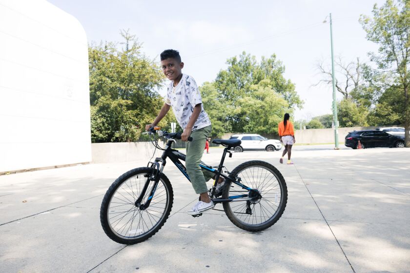 Elias rides a bike outside the the 3rd District police station at 7040 S. Cottage Grove Ave.