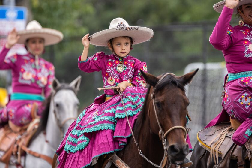 A kid rides a horse during the 20th annual Mexican Independence Day Parade along West 18th Street in the Pilsen neighborhood, Saturday afternoon, Sept. 10, 2022.