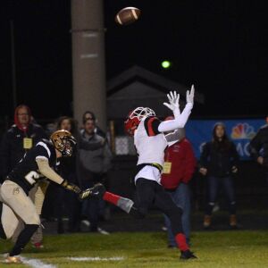 Yorkville receiver Nico Medrano (4) runs under a pass. Worsom Robinson/For the Sun-Times.