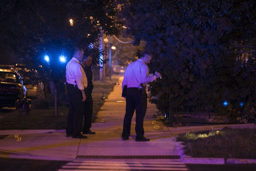 Chicago Police investigate near East 37th Street and South Michigan Avenue, where one man was killed and five women and another man were wounded in a shooting Tuesday night, Aug. 8, 2017. | Ashlee Rezin/Sun-Times