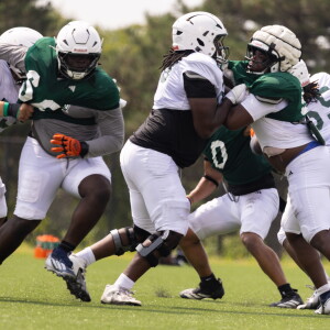 Chicago State University football players practice Wednesday on campus in Roseland.