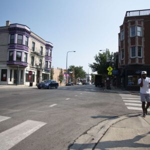 Pedestrians cross Buckingham Place at Halsted Street. | Colin Boyle/Sun-Times