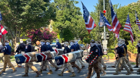 Masked members of the group Patriot Front wear masks as they march through Washington before Independence Day events honoring the nation's 250th anniversary, Saturday, July 4, 2026.