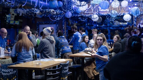 People drink at 8 Crazy Nights, a Hanukkah-themed bar in Lake View, Saturday, Dec. 13, 2025.