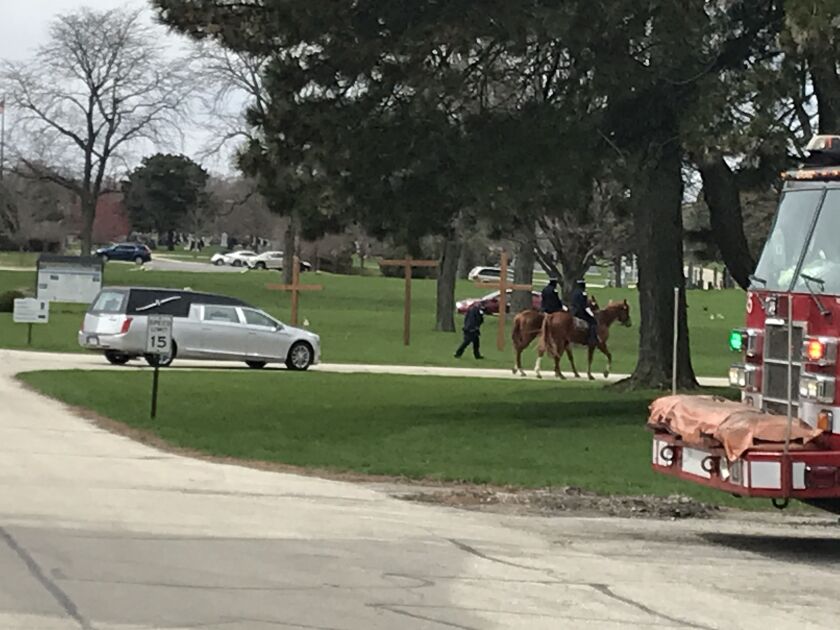 Chicago Police Officer Marco DiFranco’s hearse enters All Saints Cemetery & Mausoleum in Des Plaines on Thursday.