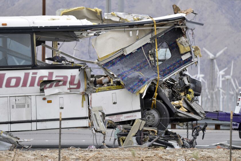 The damaged front of a tour bus is seen after it crashed into the back of a semi-trailer. | Rodrigo Pena/AP