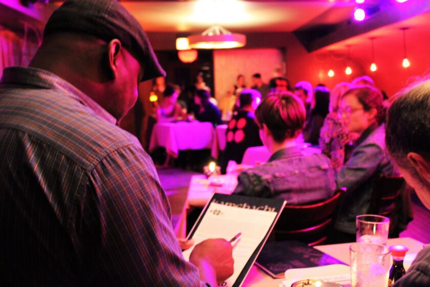 Audience member Gus White, 36, signs a waiver form before the BATSU! performance to try to participate in the show. | Talia Beechick/Sun-Times
