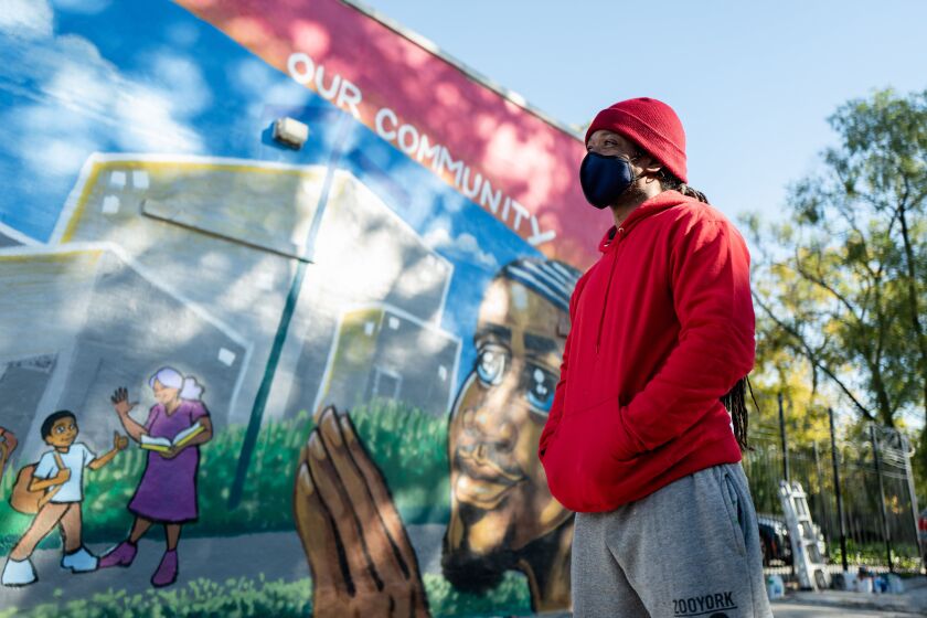 Artist Jerrold “Just Flo” Anderson, in front of a mural he painted on the Planned Parenthood at 6059 S. Ashland Ave. in Chicago’s Englewood community. “I am showing how we are striving to be the change we all need to see.”
