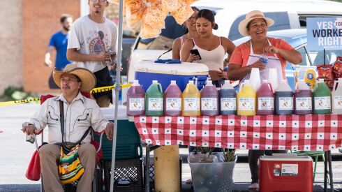 Vendors watch Saturday during the Chicago Labor Day Parade parade.