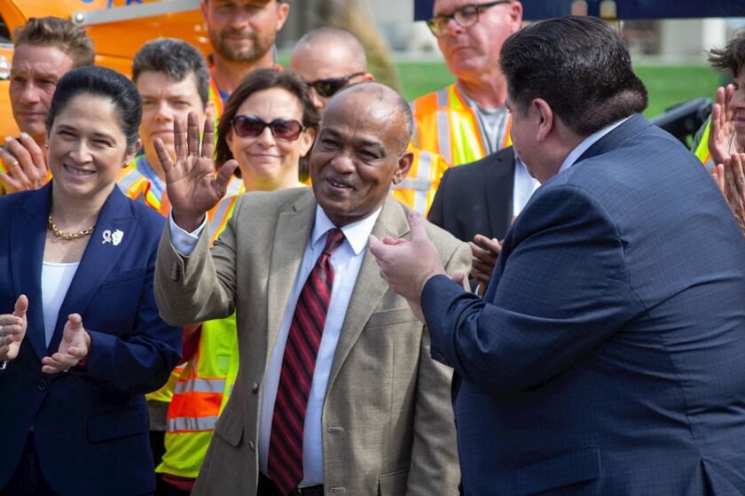 Omer Osman, director of the Illinois Department of Transportation, waves during a Springfield news conference in 2019.