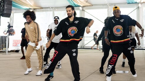 Ibrahim Sabbi (center), who won the 2025 Body House Dance Battle during the Chicago House Dance Summit at Millennium Park, dances with footwork performers.