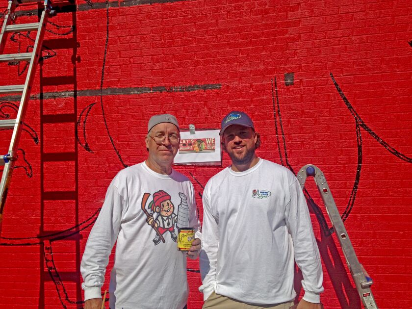 <small><strong>Ches Perry and his son, Alex Perry, were painting a Blackhawks mural on Tuesday. | Mitch Dudek/Sun-Times</strong></small>