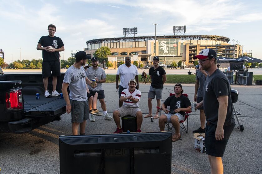 Fans of the Chicago White Sox tailgate outside of Guaranteed Rate Field during the Opening Day game against the Minnesota Twins, Friday afternoon, July 24, 2020.