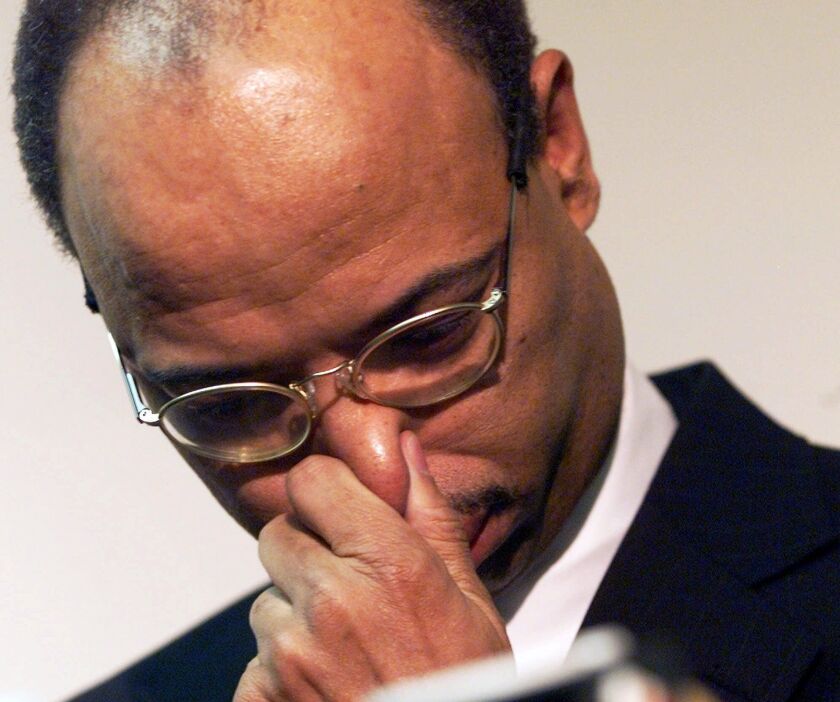 Former Rep. Mel Reynolds reacts after arriving at Chicago’s Midway Airport on Tuesday, Jan. 23, 2001. File Photo.