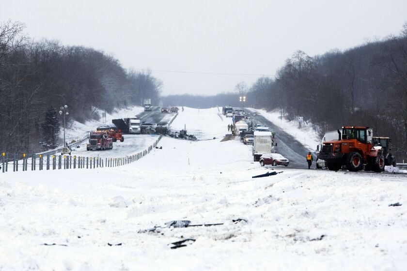 <small><strong>Road crews work to clear wrecked vehicles and debris along Interstate 94, Saturday, Jan. 10, 0215, the day after a series of crashes closed the highway between mile markers 88 and 92 in eastern Kalamazoo County, near Galesburg, Mich. The nu