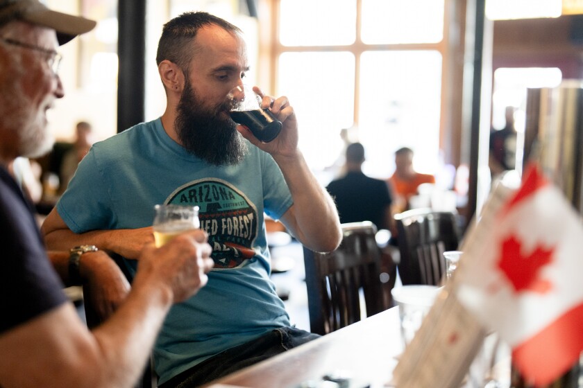Rob Lundskow drinks at Hopleaf on Canada Day, Tuesday, July 1, 2025. The bar celebrates the day with Canadian drinks and dishes.