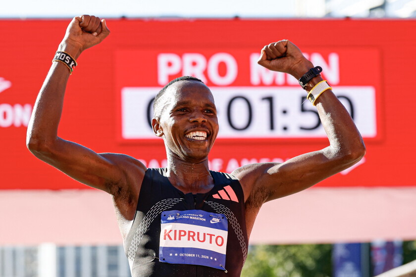 Amos Kipruto celebrates as he crosses the finish line Sunday.
