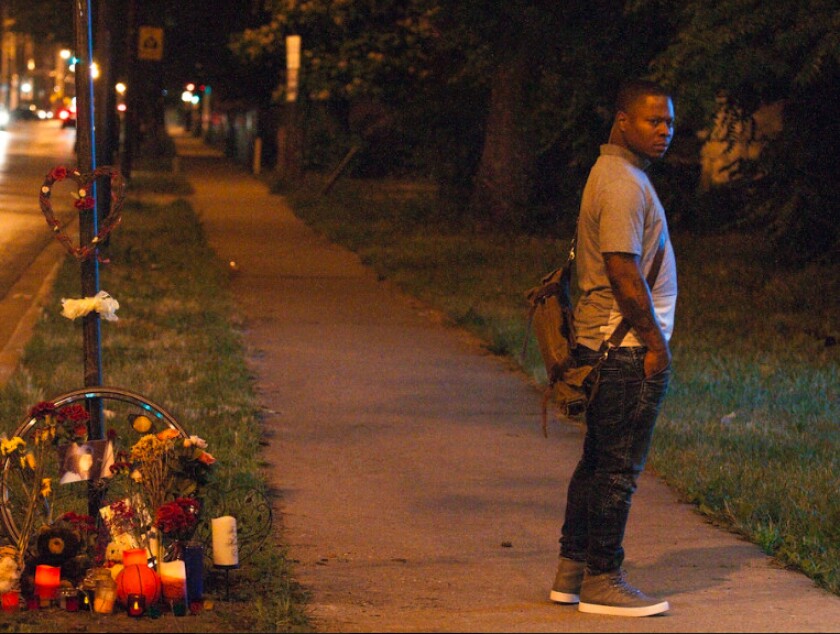 Jason Mitchell as Brandon in “The Chi,” standing next to a streetside memorial to his character’s murdered half-brother. | Showtime