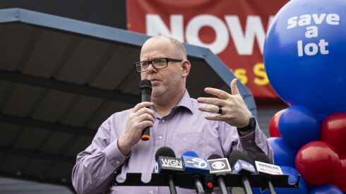 Yellow Banana CEO Joesph Canfield speaks into a mic, during the grand opening of the West Lawn Save A Lot grocery store, 4439 W. 63rd St.