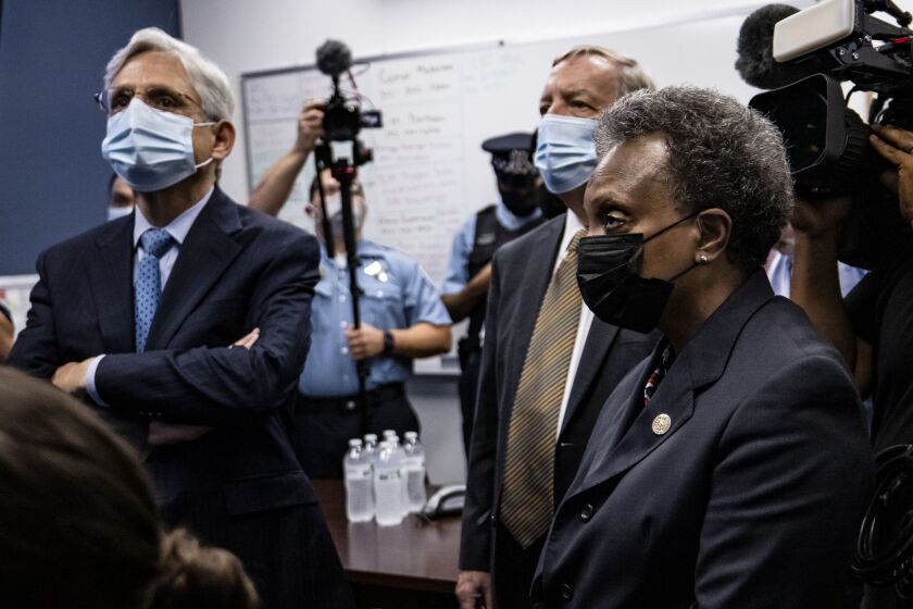 U.S. Attorney General Merrick Garland listens to a presentation alongside Sen. Dick Durbin (D-Ill.) and Chicago Mayor Lori Lightfoot while visiting the Chicago Police Department Strategic Decision Support Center on July 22, 2021 in Chicago, Illinois.