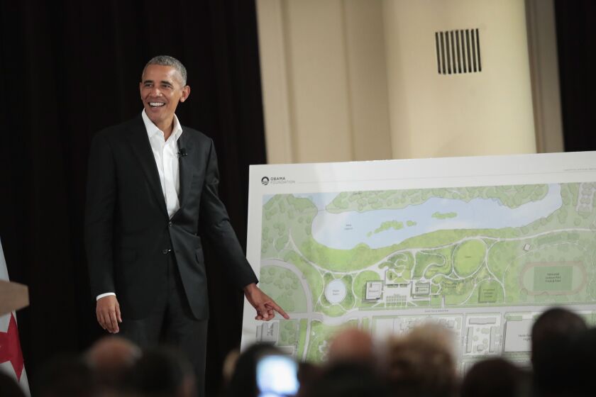 Former President Barack Obama beside a drawing of the plans for his presidential center in Jackson Park.