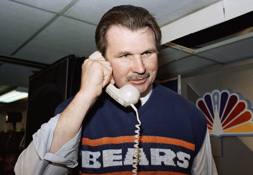 Chicago Bear head coach Mike Ditka talks to President Ronald Reagan after Super Bowl XX in New Orleans Jan. 27, 1986.