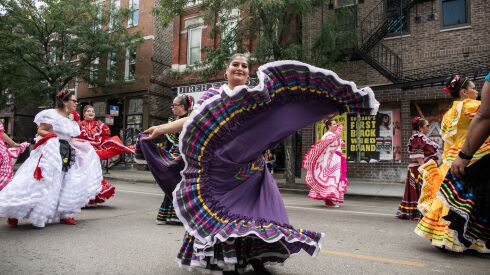 Elizabeth Ruvalcava, 48, dances during the 20th annual Mexican Independence Day Parade along West 18th Street in the Pilsen neighborhood, Saturday afternoon, Sept. 10, 2022.