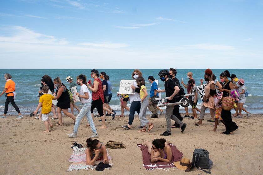 People attend a racial justice rally at Lighthouse Beach in Evanston Friday afternoon July 31, 2020 after LaShandra Smith-Rayfield confronted a group of white people displaying a Confederate flag at the beach Wednesday. | Pat Nabong/Sun-Times
