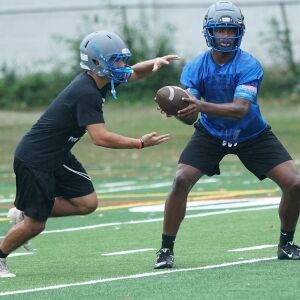 Taft’s Dexter Stigall IV hands the ball off during the first practice of the season.