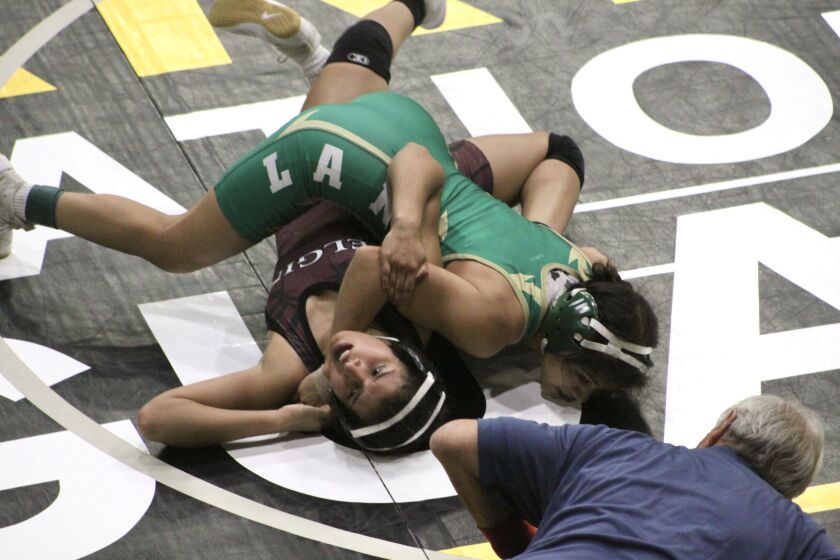 Lane’s Natalie Cortes pins Elgin’s Natalie Gonzalez in the first round of the Illinois Wrestling Coaches and Officials Association state tournament earlier this month. Both plan to wrestle in college, Cortes at Colorado Mesa and Gonzalez at Aurora.