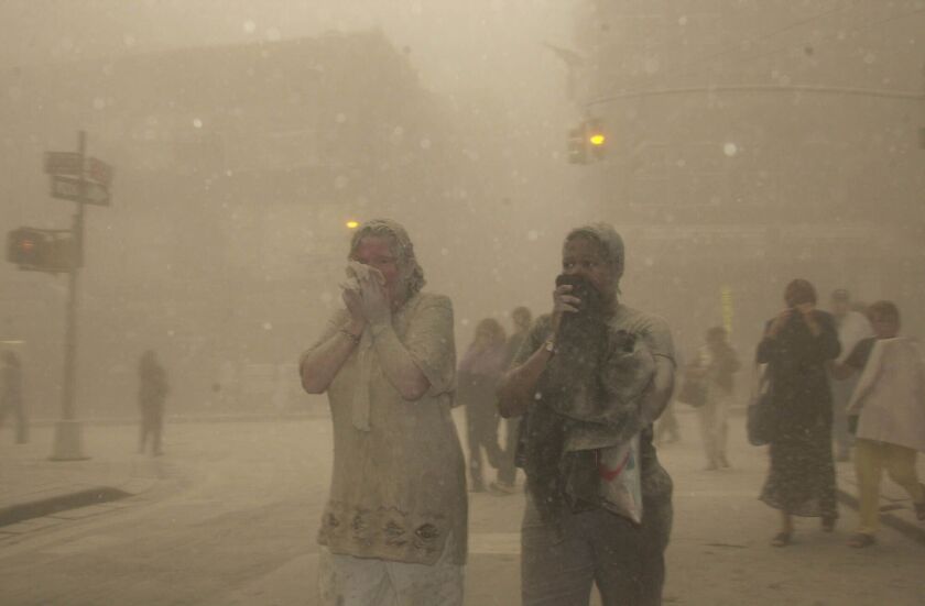 People run from the collapse of World Trade Center Tower on Sept. 11, 2001.