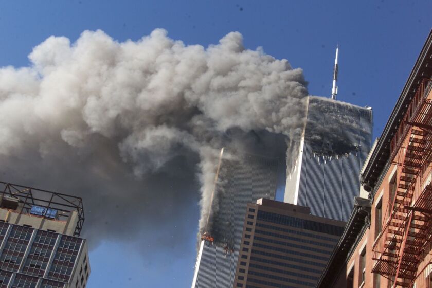 Smoke rises from the burning twin towers of the World Trade Center after hijacked planes crashed into the towers on Sept. 11, 2001.