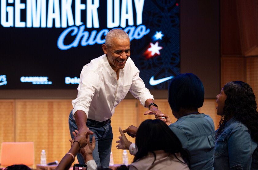 Former President Barak Obama surprises a group of high school freshman girls Friday during the WNBA Changemaker Day at the Obama Presidential Center in Jackson Park on the South Side.