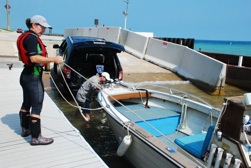Laura Knapp, the Vice Commodore of the North Shore Yacht Club in Highland Park, pulls in a boat after searching Lake Michigan for a missing kayaker. | Neesa Sweet/for the Sun-Times