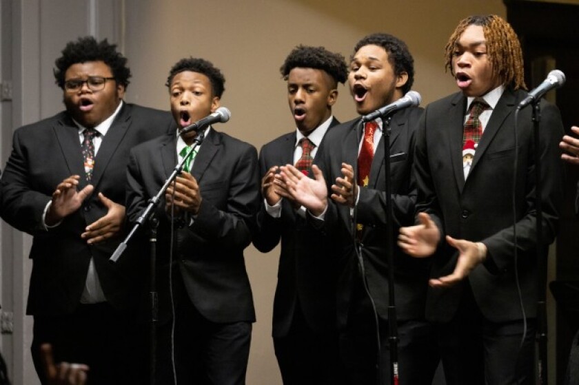 Members of the Leo Excessive College Choir on Chicago's South Aspect Maintain During A Iciness Concert in 2022.