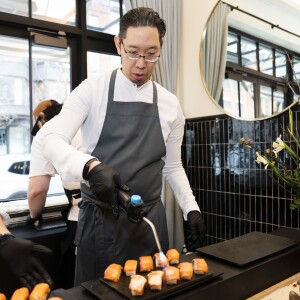 Executive Chef and Partner of Boka Restaurant Group Gene Kato prepares nigiri.