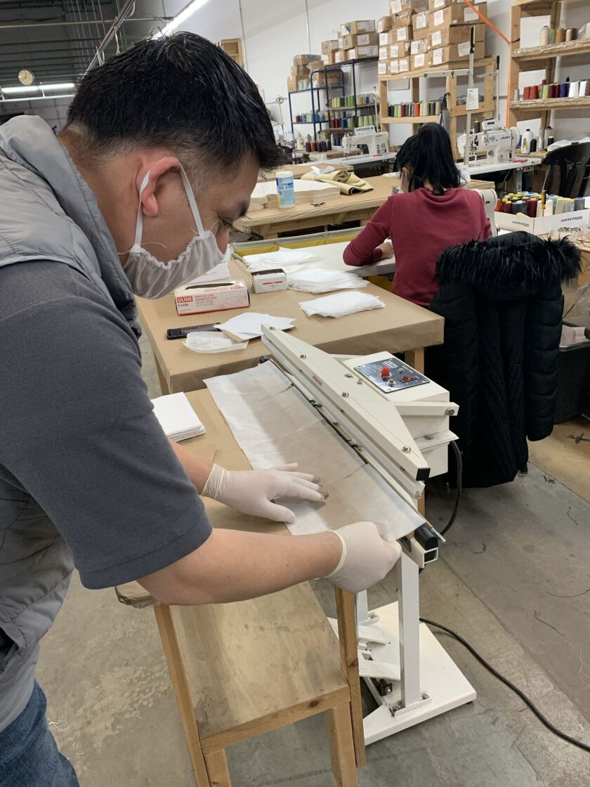 A worker at The Howard Elliott Collection creates personal protective equipment.