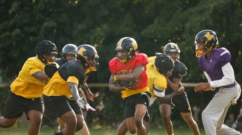 King’s Herman Yancey (red jersey) carries the ball during a drill at practice on Wednesday.