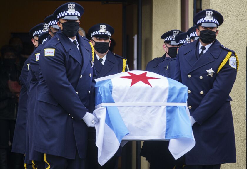 Pallbearers carry the casket for Chicago Police Field Training Officer Titus Moore after his funeral at Leak & Sons Funeral Home on the South Side, Tuesday afternoon, Dec. 8, 2020. Moore, 46, died Nov. 24 of complications from COVID-19 while quarantining at home and family members were initially upset the police department hadn’t declared that Moore died in the line of duty.