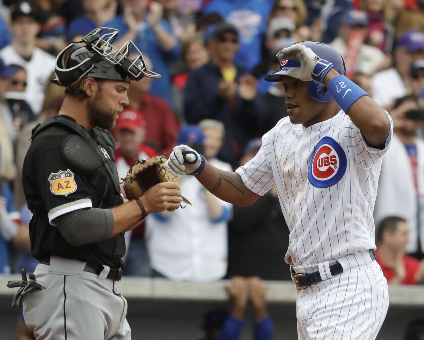 Russell celebrates his home run as he crosses home in front of White Sox catcher Kevan Smith.