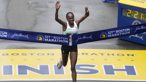 Hellen Obiri, of Kenya, breaks the tape at the finish line to win the women’s division of the Boston Marathon.