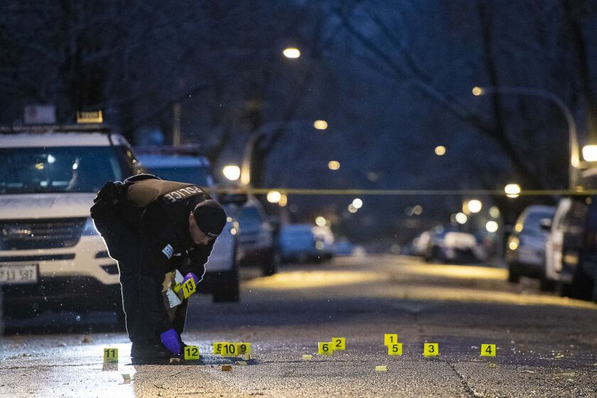 Police investigate the scene where three people were wounded whiled traveling in a vehicle, Sunday morning in the 6500 block of South Hoyne in the Englewood neighborhood. | Tyler LaRiviere/Sun-Times
