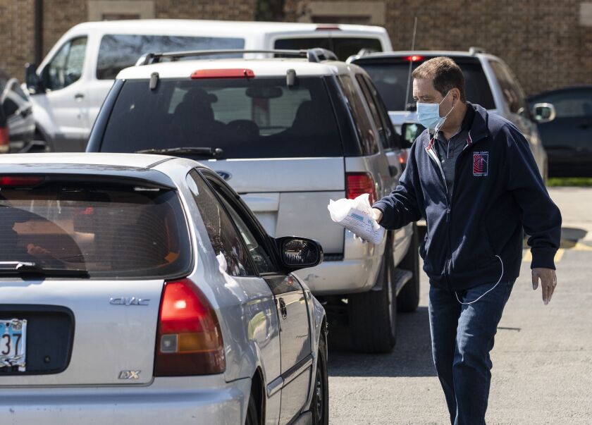 U.S. Rep. Jesus “Chuy” Garcia helped hand out masks and hand sanitizer at a drive-thru event in Little Village in May.