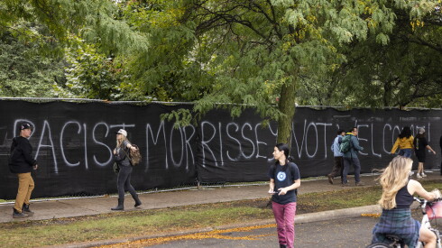 Graffiti reads “Racist Morrissey not welcome!” on the exterior fence at Douglass Park.