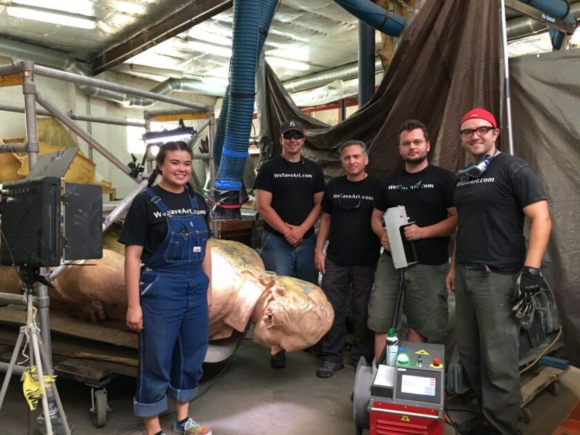 The team overssing the cleaning and re-gilding of the Alexander Hamilton sculpture that stands in Lincoln Park includes (from left) Kathren Lee, Johnathan Murach, Dr. Andrzej Dajnowski, Bartosz Dajnowski and Christopher Ciaston. (Photo: Hedy Weiss)