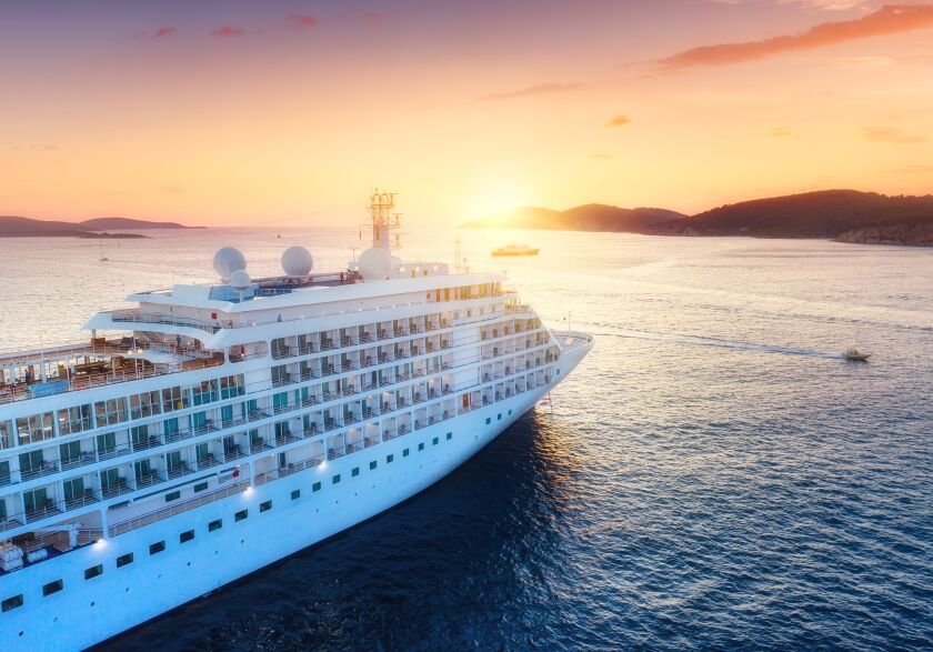 A cruise ship on the water. A travel consultant recommends checking ahead about what kind of medical facilities, staff, and supplies a cruise ship has.