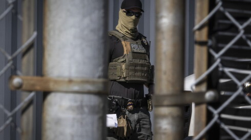 An Immigration and Customs Enforcement officer escorts a detainee into the ICE facility in Broadview, Wednesday, Sept. 17, 2025.