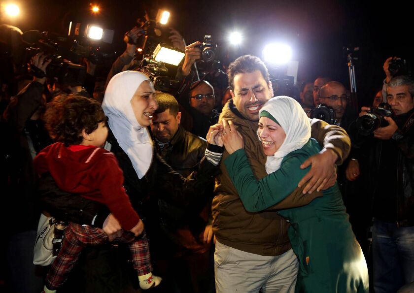 A man comforts the wife of Jordanian pilot, Lt. Muath al-Kaseasbeh, who is held by the Islamic State group militants. Jordan offered a prisoner swap to the Islamic State group in a desperate attempt to save a Jordanian air force pilot the militants purpor