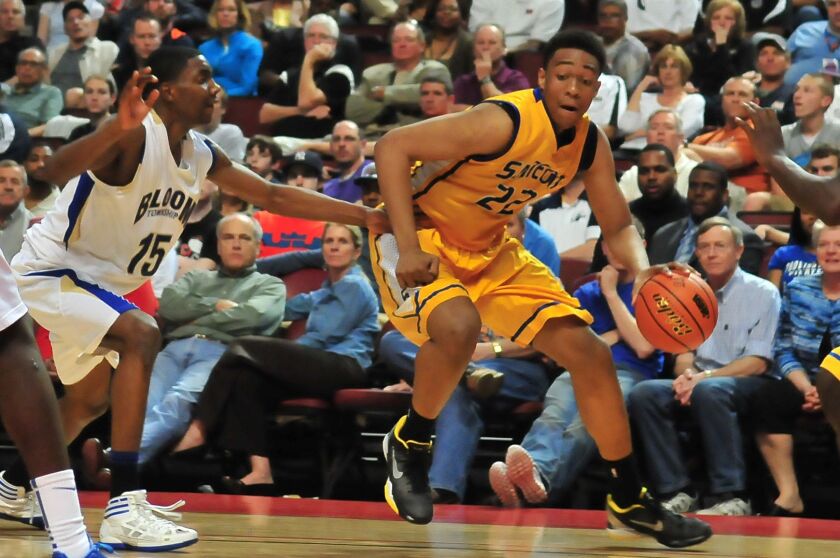 Jabari Parker of Simeon looks to move inside as Bloom’s Johnny Griffin rushes to defend.