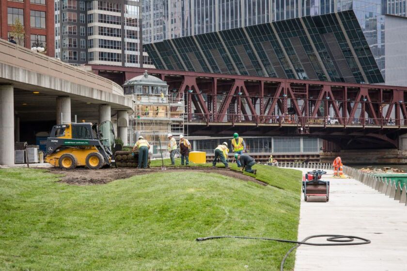 Crews working Wednesday near Franklin Street on the Chicago Riverwalk. | Santiago Covarrubias/Sun-Times